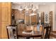 Cozy kitchen area features stainless appliances, wooden cabinetry, with a breakfast table with chairs in the foreground at 22554 Treetop Ln, Golden, CO 80401