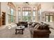 Spacious living room with high ceilings, large windows offering natural light, and comfortable seating arrangement at 22554 Treetop Ln, Golden, CO 80401