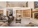 Spacious living room featuring a wet bar, fireplace, comfortable seating, and access to a second story at 22554 Treetop Ln, Golden, CO 80401