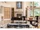 Open floorplan of living room and dining room, showcasing fireplace, built-in shelves, and natural light at 22554 Treetop Ln, Golden, CO 80401