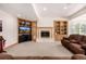 Inviting living room featuring a stone fireplace and custom built-in shelving at 22554 Treetop Ln, Golden, CO 80401
