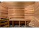 Luxurious sauna featuring natural wood paneling, a built-in bench, and slate flooring at 22554 Treetop Ln, Golden, CO 80401