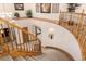 Sweeping staircase with wood banister and plush carpet, leading to the upper level at 22554 Treetop Ln, Golden, CO 80401