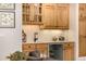 Wet bar with wine refrigerator and wooden cabinetry at 22554 Treetop Ln, Golden, CO 80401