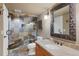 Elegant bathroom showcases tiled shower, vanity, and decorative mirror at 15 Amaranth Dr, Littleton, CO 80127