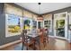 Well-lit dining room features big windows, a patterned overhead light, and views of the surrounding greenery at 15 Amaranth Dr, Littleton, CO 80127