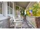 Cozy front porch seating area with rocking chairs and American flag at 15 Amaranth Dr, Littleton, CO 80127