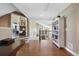 Bright hallway with hardwood floors, built in bookcase and views of living room and stairway at 15 Amaranth Dr, Littleton, CO 80127