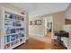 Inviting hallway with hardwood floors, built-in bookcase, and views into another living area at 15 Amaranth Dr, Littleton, CO 80127