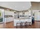 Bright kitchen featuring white cabinets, hardwood floors, stainless steel appliances, and a large center island at 15 Amaranth Dr, Littleton, CO 80127