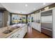 An expansive kitchen with an island sink, stainless fridge, granite counters and an adjacent dining area at 15 Amaranth Dr, Littleton, CO 80127