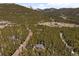 An aerial view showcasing a property nestled within a lush forest at 400 Upper Forest Rd, Idaho Springs, CO 80452