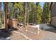 A charming backyard with towering trees, a shed, a cozy hammock, and unique rock landscaping at 400 Upper Forest Rd, Idaho Springs, CO 80452