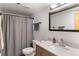 Bathroom featuring a modern vanity, toilet, and tub shower with gray curtain at 400 Upper Forest Rd, Idaho Springs, CO 80452