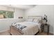 Serene bedroom featuring neutral tones, soft lighting, and a window with a green view at 400 Upper Forest Rd, Idaho Springs, CO 80452