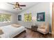 Cozy bedroom with hardwood floors, nature view windows, and charming decor at 400 Upper Forest Rd, Idaho Springs, CO 80452