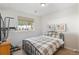 This bedroom features carpet floors, a metal-framed bed with plaid comforter, and an open window at 400 Upper Forest Rd, Idaho Springs, CO 80452