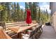 Outdoor deck features wooden furniture, an umbrella, and a grill perfect for gatherings at 400 Upper Forest Rd, Idaho Springs, CO 80452