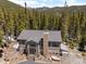 Stunning aerial view of exterior showcasing beautiful home nestled amongst dense trees at 400 Upper Forest Rd, Idaho Springs, CO 80452
