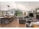 Open concept living room features a modern gray kitchen with large island and wood floors at 400 Upper Forest Rd, Idaho Springs, CO 80452