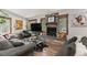 Cozy living room featuring a stone fireplace, wood floors, and comfortable seating at 400 Upper Forest Rd, Idaho Springs, CO 80452
