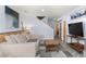 Cozy living room with comfortable seating, a TV, and an open staircase at 400 Upper Forest Rd, Idaho Springs, CO 80452