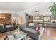 Open concept living area leading to a modern gray kitchen with large island and wood floors at 400 Upper Forest Rd, Idaho Springs, CO 80452