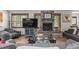 Cozy living room featuring a stone fireplace, wood floors, and comfortable seating at 400 Upper Forest Rd, Idaho Springs, CO 80452