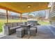 Inviting outdoor patio with stylish wicker furniture and a relaxing hot tub at 7153 S Cody Cir, Littleton, CO 80128