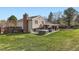 Spacious backyard featuring a well-maintained lawn, patio, hot tub, and home exterior at 7153 S Cody Cir, Littleton, CO 80128