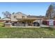 Expansive backyard featuring a covered patio, hot tub, storage shed and lawn space at 7153 S Cody Cir, Littleton, CO 80128
