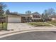 Inviting two-story home with a spacious driveway, attached garage, and manicured landscaping at 7153 S Cody Cir, Littleton, CO 80128