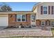 Charming home featuring a brick facade, decorative shutters, and a welcoming front entrance at 7153 S Cody Cir, Littleton, CO 80128