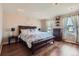 Bright bedroom with hardwood floors, recessed lighting, and large windows for natural light at 7153 S Cody Cir, Littleton, CO 80128