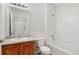 Bathroom with a shower over tub, single sink vanity, and a view to the hallway at 2705 S Danube Way # 103, Aurora, CO 80013