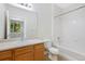 Bathroom with a shower over tub, single sink vanity, and window view to outside at 2705 S Danube Way # 103, Aurora, CO 80013