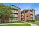 Attractive condo building features brick accents and multiple balconies at 2705 S Danube Way # 103, Aurora, CO 80013