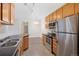 Modern kitchen with stainless steel appliances and a view to the light-filled dining room at 2705 S Danube Way # 103, Aurora, CO 80013