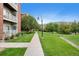 Exterior pathway with trees and manicured lawns on either side of the street at 2705 S Danube Way # 103, Aurora, CO 80013