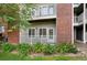 Balcony featuring a white railing and shade trees and a stone wall exterior at 2705 S Danube Way # 103, Aurora, CO 80013