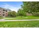 Beautifully landscaped yard featuring mature trees and walking paths at 2705 S Danube Way # 103, Aurora, CO 80013