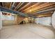 Spacious unfinished basement featuring exposed beams and concrete flooring at 4732 S Coolidge St, Aurora, CO 80016