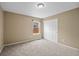Bedroom with neutral walls, carpet and sliding closet doors at 4732 S Coolidge St, Aurora, CO 80016
