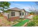 Home exterior with brick accents, neutral siding, and backyard patio at 4732 S Coolidge St, Aurora, CO 80016