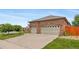 Spacious three car garage attached to a brick home at 4732 S Coolidge St, Aurora, CO 80016
