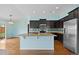 Modern kitchen with dark wood cabinets, granite countertops, and stainless steel appliances at 4732 S Coolidge St, Aurora, CO 80016