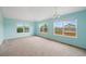 Bright living room features neutral carpet and large windows with views of the surrounding neighborhood at 4732 S Coolidge St, Aurora, CO 80016