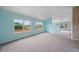 Bright and airy living area with large windows, neutral paint, and carpeting throughout at 4732 S Coolidge St, Aurora, CO 80016