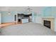 Open-concept living room area with a fireplace, and direct access to the kitchen at 4732 S Coolidge St, Aurora, CO 80016