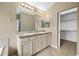 Main bathroom includes double sinks, a large mirror, and access to the walk-in closet at 4732 S Coolidge St, Aurora, CO 80016